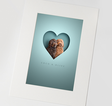 Load image into Gallery viewer, Modern pet picture of two cockapoos sitting in a cutout style heart shape creating an unusual 3d look. Aqua blue background colour and in an off white textured mount.