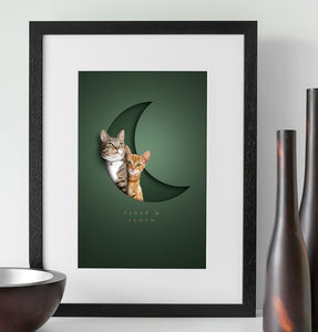cute cat picture with a realistic 3D look. A tabby and a ginger cat sit together in a crescent moon paper cutout with their names underneath in an elegant typeface
