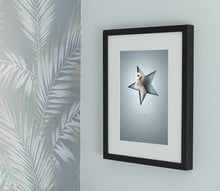 Load image into Gallery viewer, stylish, modern 3D-effect pet picture with white dog sitting in a star shape with a paper cutout look giving an unusual 3d effect. Framed in a black picture frame and hanging on a wall