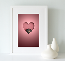 Load image into Gallery viewer, black and tan dachshund dog looking out of a heart shape cut out on a pink background and framed in a white wooden picture rame