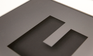 close up image showing the texture and quality of the dark grey design with the cut out effect of the capital letter F