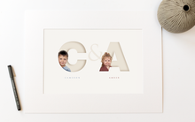 Load image into Gallery viewer, picture in photo mount of two children, each one sitting inside the initial letter of their name and their full name written below in a classy serif font
