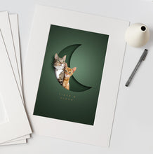 Load image into Gallery viewer, stylish pet and cat picture with an unusual 3d effect of 2 cats sitting in a moon shaped paper cutout design on a dark green background. Their names are underneath in a serif typeface. The print is in an off-white textured mount ready for framing