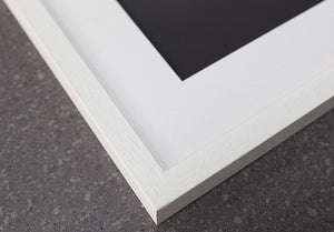 detail of white wooden picture frame